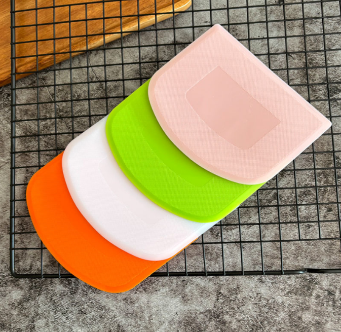 A baking scraper with anti-slip points for cutting dough